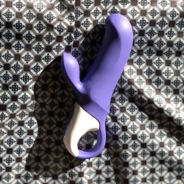 Magic Bunny vibrator - purple rabbit vibe on background of blue diamonds in satin fabric