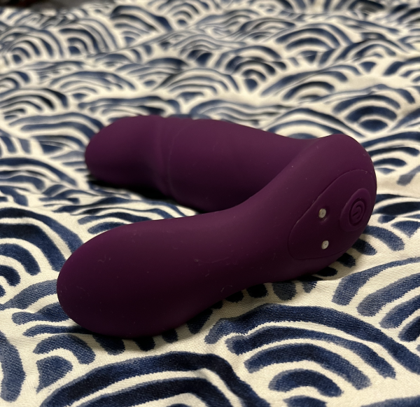 Lucky 7 by Tracy's Dog purple dildo lying on blue and white wave pattern fabric